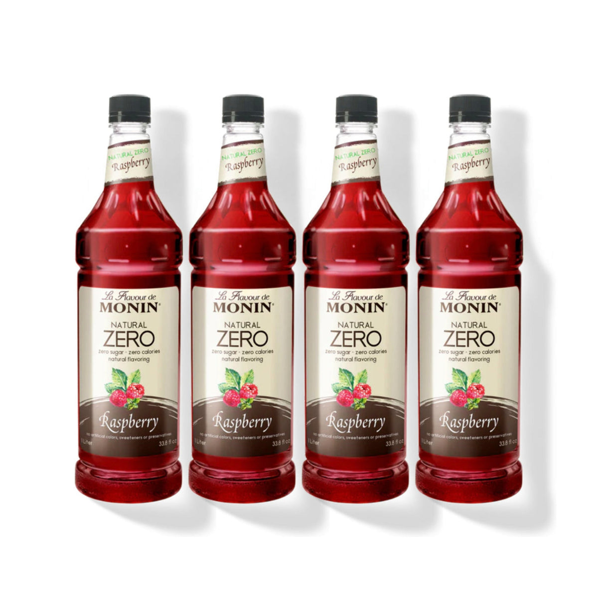 Four 1L plastic bottles of Monin Natural Zero Raspberry syrup in a row